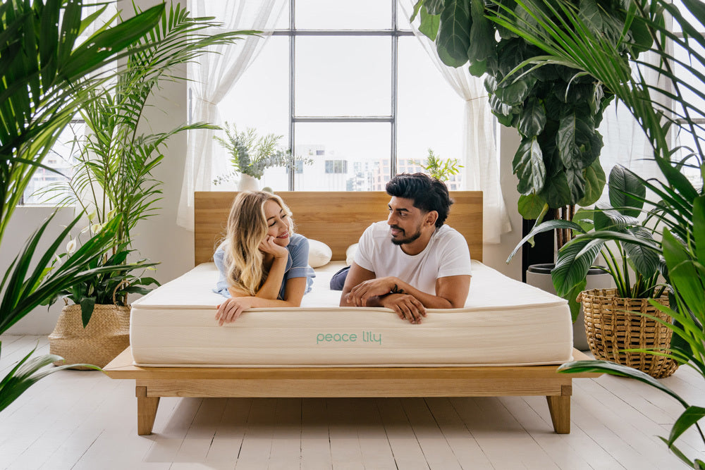 Couple lying on a Peace Lily brand latex mattress