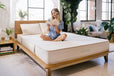 girl on peace lily latex mattress with a book