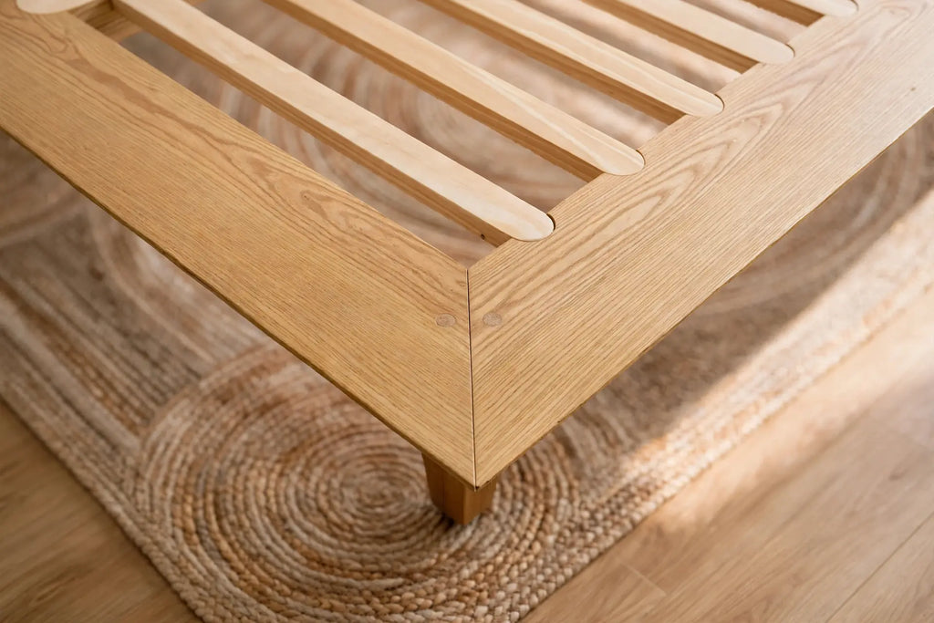 Corner detail of the Peace Lily Timber Bed Frame showing the slat rail and solid ash joinery